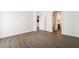 A bright bedroom with wood-look floors, white walls, and entry to the bathroom at 10458 Gabaldon St, Las Vegas, NV 89141
