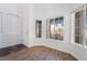 Entryway filled with natural light from multiple windows and stylish wood-look floors at 10458 Gabaldon St, Las Vegas, NV 89141