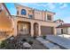 Charming two-story home features a covered porch, desert landscaping, and an attached two-car garage at 10458 Gabaldon St, Las Vegas, NV 89141