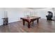 Spacious game room with a pool table, arcade game, and wood-look flooring at 10458 Gabaldon St, Las Vegas, NV 89141