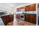 Modern kitchen features stainless steel appliances, granite countertops, and rich wood cabinets at 10458 Gabaldon St, Las Vegas, NV 89141