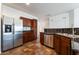 Kitchen features stainless steel appliances, dark wood cabinetry, and a tile floor at 10458 Gabaldon St, Las Vegas, NV 89141