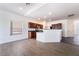 Bright living room view of kitchen area with modern finishes and sleek wood flooring at 10458 Gabaldon St, Las Vegas, NV 89141