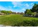 A community park with green grass, walking path, mature trees, and scenic neighborhood views at 10458 Gabaldon St, Las Vegas, NV 89141