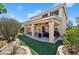 Backyard featuring artificial turf, patio, and landscaped areas at 10948 Carberry Hill St, Las Vegas, NV 89141