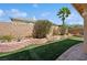 Landscaped backyard featuring artificial turf and stone planters at 10948 Carberry Hill St, Las Vegas, NV 89141