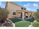 Inviting backyard with a covered patio and artificial turf, perfect for outdoor living and entertaining at 10948 Carberry Hill St, Las Vegas, NV 89141