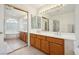 Bathroom with double sinks, soaking tub, and large mirrored closet at 10948 Carberry Hill St, Las Vegas, NV 89141