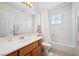 Bright bathroom features a vanity with cabinets, and a shower-tub combo at 10948 Carberry Hill St, Las Vegas, NV 89141