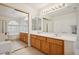 Primary bathroom with double sinks, large mirror, and separate tub and shower at 10948 Carberry Hill St, Las Vegas, NV 89141
