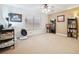 Bright, carpeted bedroom with neutral walls, a ceiling fan, and ample natural light at 10948 Carberry Hill St, Las Vegas, NV 89141