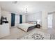 Large bedroom with elegant chandelier, natural light, and neutral decor at 10948 Carberry Hill St, Las Vegas, NV 89141