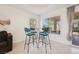 Dining area featuring tile floors, large windows, and a table with four chairs at 10948 Carberry Hill St, Las Vegas, NV 89141