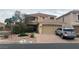 Charming two-story home with a tile roof, manicured landscaping, and a two-car garage at 10948 Carberry Hill St, Las Vegas, NV 89141