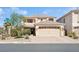 Two-story home with a large front yard, desert landscaping, and an attached two-car garage at 10948 Carberry Hill St, Las Vegas, NV 89141