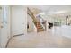Foyer with tile floors, staircase with wood railing, and entrance to the dining and living area at 10948 Carberry Hill St, Las Vegas, NV 89141