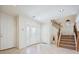 Foyer featuring tile floors, a staircase, white walls, and a door leading to another room at 10948 Carberry Hill St, Las Vegas, NV 89141