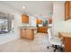 Open kitchen featuring oak cabinets, granite countertops, and tiled flooring at 10948 Carberry Hill St, Las Vegas, NV 89141