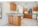 Well-lit kitchen with oak cabinets, granite counters, and modern appliances at 10948 Carberry Hill St, Las Vegas, NV 89141
