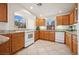 Spacious kitchen with oak cabinets, granite countertops, and a white range at 10948 Carberry Hill St, Las Vegas, NV 89141