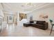 Spacious living room featuring a modern fireplace, stylish staircase, and tray ceiling at 10948 Carberry Hill St, Las Vegas, NV 89141
