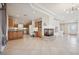 Open-concept living space with kitchen access, fireplace, and tiled flooring at 10948 Carberry Hill St, Las Vegas, NV 89141