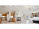 Open-concept layout with kitchen view, fireplace, and staircase at 10948 Carberry Hill St, Las Vegas, NV 89141