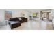 Living room featuring tile floors, large windows, a couch, and a table with chairs at 10948 Carberry Hill St, Las Vegas, NV 89141