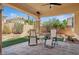 Relaxing covered patio with seating and manicured backyard at 10948 Carberry Hill St, Las Vegas, NV 89141