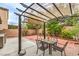 This backyard includes a pergola over outdoor seating and mature trees at 11177 Deluna St, Las Vegas, NV 89141