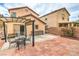 Backyard view showing brick pavers, pergola, outdoor kitchen area and landscaping at 11177 Deluna St, Las Vegas, NV 89141