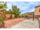 A cozy backyard with brick pavers and a pergola with seating arrangement at 11177 Deluna St, Las Vegas, NV 89141