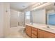 Bright bathroom featuring a double sink vanity and shower over tub at 11177 Deluna St, Las Vegas, NV 89141