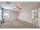Spacious bedroom with plush carpet, ceiling fan, and window offering natural light and comfort at 11177 Deluna St, Las Vegas, NV 89141