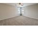 Bright and airy bedroom with neutral carpet, ceiling fan, and window with curtains at 11177 Deluna St, Las Vegas, NV 89141
