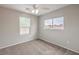 Bedroom featuring two windows with backyard views and neutral carpet at 11177 Deluna St, Las Vegas, NV 89141