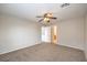 Comfortable carpeted bedroom featuring a ceiling fan and views into an adjacent bathroom at 11177 Deluna St, Las Vegas, NV 89141