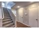 Hallway featuring carpeted stairs leading upstairs, hardwood floors, and two doors leading to other rooms at 11177 Deluna St, Las Vegas, NV 89141