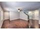Spacious living room featuring sleek hardwood floors, a ceiling fan, and ample natural light at 11177 Deluna St, Las Vegas, NV 89141