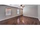 Bright living room featuring sleek hardwood floors and ample natural light through large windows at 11177 Deluna St, Las Vegas, NV 89141