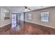 Open-concept living room with hardwood floors connects to the kitchen and a sliding door to the patio at 11177 Deluna St, Las Vegas, NV 89141