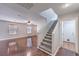 Spacious living room with wood floors, a ceiling fan, and stairs leading to the second floor at 11177 Deluna St, Las Vegas, NV 89141