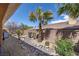 Desert landscaped backyard featuring natural rock accents and palm trees at 11177 Twilight Times Ct, Las Vegas, NV 89135