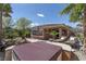 Desert landscaped backyard featuring a jacuzzi, patio, and well maintained lawn at 11177 Twilight Times Ct, Las Vegas, NV 89135