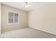 Empty bedroom features neutral paint, carpet, a ceiling fan, and a window with shutters at 11177 Twilight Times Ct, Las Vegas, NV 89135