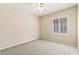 Neutral bedroom with carpet, a ceiling fan, and bright window with white trim at 11177 Twilight Times Ct, Las Vegas, NV 89135