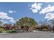 Charming home featuring a well-manicured front yard with mature trees and desert landscaping, creating inviting curb appeal at 11177 Twilight Times Ct, Las Vegas, NV 89135