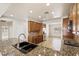 Modern kitchen featuring granite countertops, stainless steel appliances, and tile flooring at 11177 Twilight Times Ct, Las Vegas, NV 89135