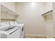 Laundry room with washer and dryer and overhead storage shelves at 11177 Twilight Times Ct, Las Vegas, NV 89135