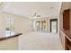 Bright living area featuring sliding glass doors, plush carpet, ceiling fan and an open-concept design with natural light at 11177 Twilight Times Ct, Las Vegas, NV 89135